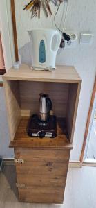 a table with a tea kettle on top of it at Căsuța Sara- the story of nature in Plopi