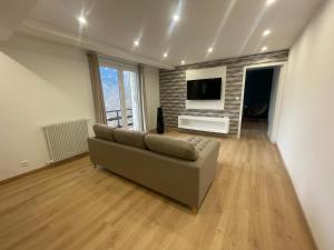 a living room with a couch and a flat screen tv at Serre 2 in Belvédère