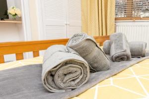 a bed with a blanket and pillows on it at Aberdeen Nest in Aberdeen