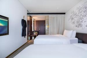 Postel nebo postele na pokoji v ubytování CitiGO Hotel Hongqiao Shanghai + 28 fotografií