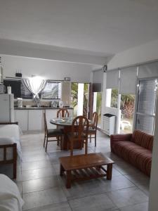 a kitchen and living room with a table and chairs at Loft con pileta en Barrio San Carlos Mar del Plata in Mar del Plata