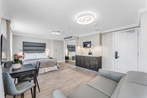a hotel room with a bed and a living room at Cleveland Residences Bloomsbury in London