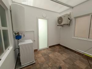 an empty room with a fan and a window at O nido do cuco in Muxia +42 photos
