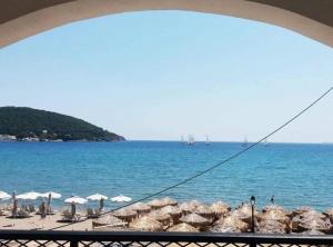 a view of a beach with umbrellas and the ocean at Kanali seaside apartment Poros 2 in Poros