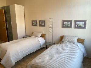 two beds sitting next to each other in a room at Zweitbettzimmer Hannover in Hannover +3 photos
