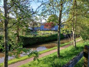 a river running through a park with trees at Coach & Horses Inn in Crickhowell