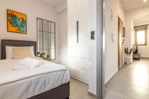 a bedroom with a large bed and a hallway at Gianna's Apartments in Bendevís