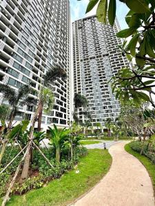 two tall buildings with palm trees in a park at 17FL LUX Studio Room Apartment, Great View in Phnom Penh