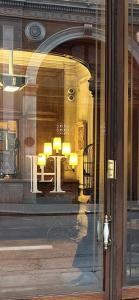 a reflection of a table in a store window at Hôtel Langlois in Paris +89 photos