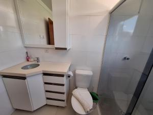 a small bathroom with a toilet and a shower at Pousada Recanto Barão de Biguaçu in Biguaçu +24 photos