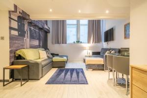 a living room with a couch and a table at Align Lux Apartments, Liverpool City Centre in Liverpool