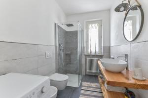 a white bathroom with a sink and a toilet at Casa Melete - Goelba in Seccheto