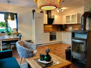 a kitchen and living room with a table and a couch at Lieblingsstück in Tanne