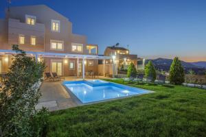 a house with a swimming pool in the yard at Blue Hills Villas by Estia in Agia Pelagia