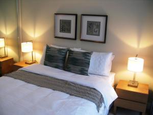 a bedroom with a bed and a lamp at Link Portside in Brisbane