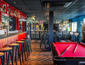 a pool table in a bar with stools at Botel in Amsterdam +33 photos