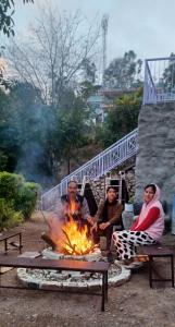 a group of men sitting around a fire at Sun Shine Haven Retreat in Kasauli