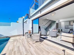 a house with a swimming pool and a living room at San Pedro del Pinatar Villa - 5010 in San Pedro del Pinatar