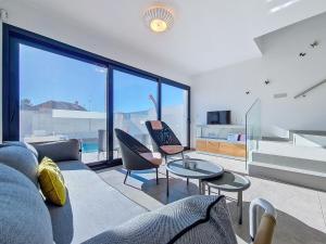 a living room with a couch and chairs and a table at San Pedro del Pinatar Villa - 5010 in San Pedro del Pinatar