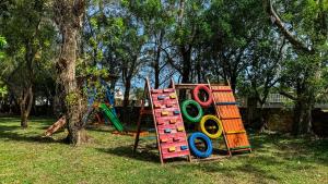 a playground with a set of colorful play equipment at Pousada Fazendinha Tatuira in Imbé