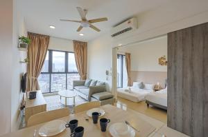 a living room with a table and a couch at Greystone Continew Residensi in Kuala Lumpur