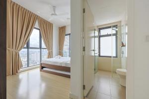 a bedroom with a bed and a shower and a toilet at Greystone Continew Residensi in Kuala Lumpur