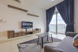 a living room with a couch and a tv at Greystone Continew Residensi in Kuala Lumpur
