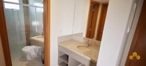 a bathroom with a sink and a toilet at Resort do LAGO - Caldas Novas in Caldas Novas +4 photos