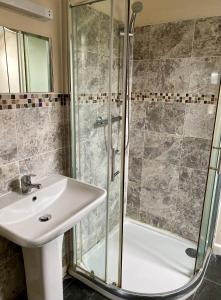 a bathroom with a sink and a shower at Fieldways in Trowbridge