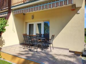 a patio with chairs and a table on a house at Aminyaralónk in Balatonmáriafürdő