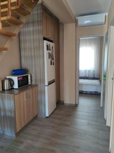 a kitchen with a refrigerator and a microwave at Aminyaralónk in Balatonmáriafürdő +6 photos
