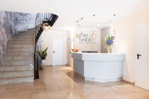 a staircase in a white room with a stair runner at Boutiquehotel Drei Ringe Schwörstadt - Rheinfelden in Schwörstadt