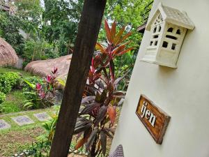 a house with a sign on the side of it at Mondo Surf Village in Canggu