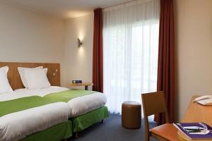 A bed or beds in a room at ibis Styles Bourbon Lancy