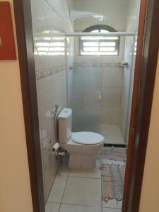 a bathroom with a toilet and a shower at Sobrado estilo Colonial in Salvador