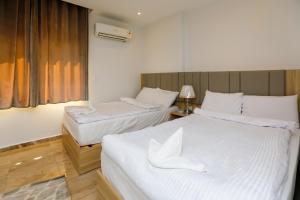 Voodi või voodid majutusasutuse Pyramids Express View Hotel toas