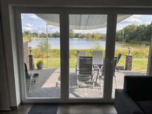 a view of a patio with a table and chairs at NEU! Ferienhaus Schöne Aussicht direkte Strandlage in Aurich +7 photos