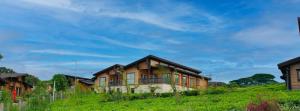 a house on top of a grassy hill at Ridge Cabin Resort in Nairobi