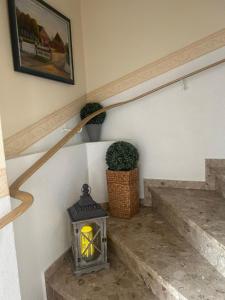 a stairway with a lantern on the side of the stairs at Ferienhof Eckhoff in Fehmarn