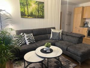 a living room with a couch and a table at Ferienhof Eckhoff in Fehmarn +32 photos