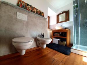 a bathroom with a toilet and a sink and a shower at Casa dello Gnomo in Rossa +10 photos