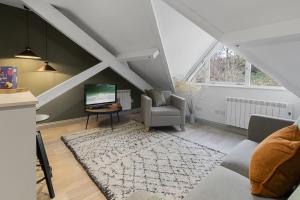 a living room with a couch and a laptop on a table at 4A The Courtyard, City Centre Apartment, Exeter in Exeter
