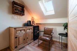 a kitchen with a table and a chair in a room at Deluxe House Maj in Brežice +31 photos
