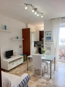a kitchen and living room with a table and chairs at Milan Top-Floor Flat City View 2 Balconies Workspace M5 in Milan