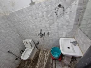 a bathroom with a toilet and a sink at Sukoon guest house in Jammu