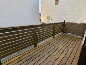 a large wooden deck in front of a building at Onasyas-B in Hakodate