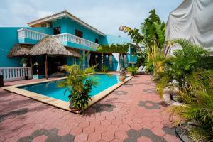 a resort with a swimming pool and a building at Casa Leonore Studio in Willemstad