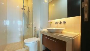 a bathroom with a sink and a toilet and a shower at Straits Quay Highest & Spacious Seaview Suite - 3 in Bagan Jermal +12 photos