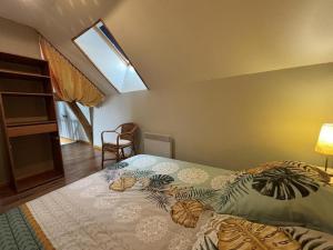 a bedroom with a bed in a room with a window at Gite de la roseraie in Louchy-Montfand +19 photos