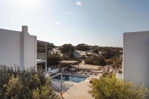 an aerial view of a building with a swimming pool at Cedar Forest Alyko Oceanfront 4BR Villa with Private Heated Pool & Beach Access in Naxos Chora